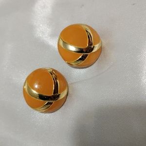 Small orange gold toned metal circle earrings